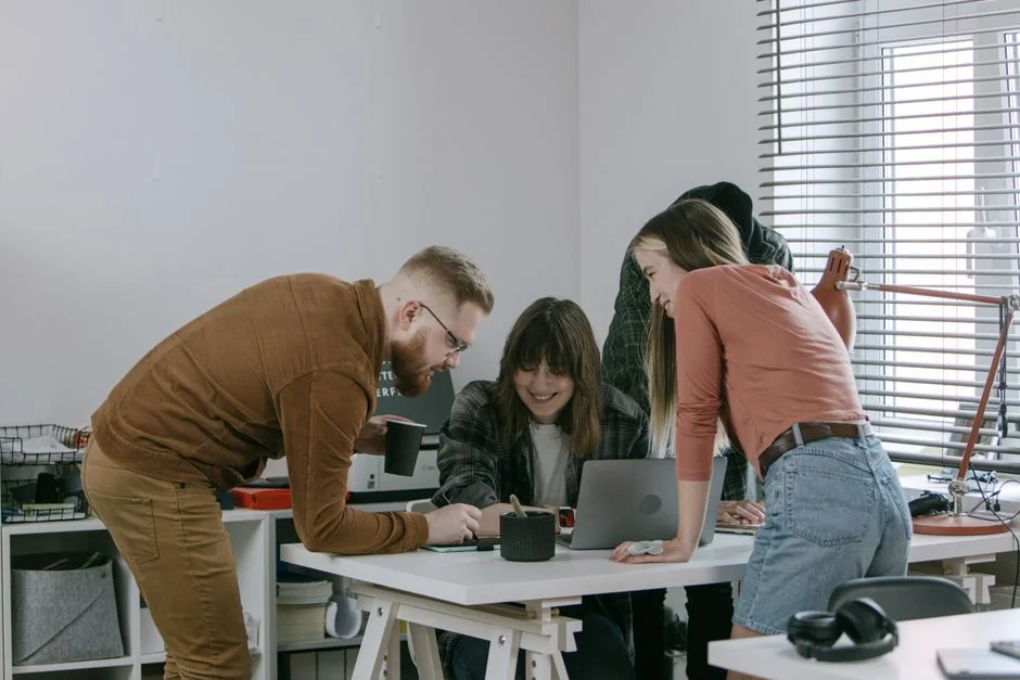 A modern workspace featuring dual computer monitors displaying web design projects, emphasizing technology and productivity.